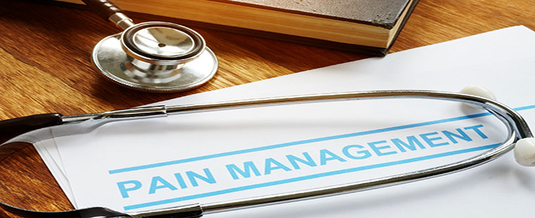 Pain management documents and stethoscope with book.